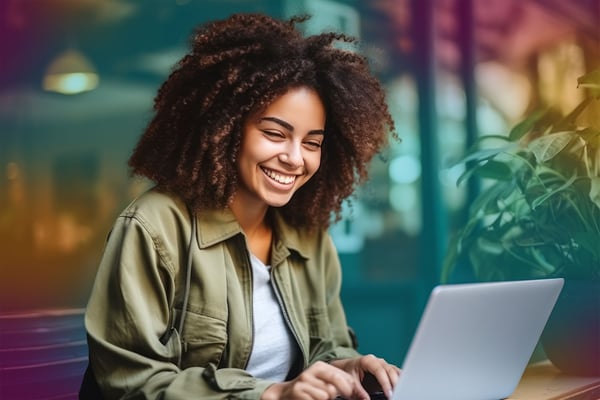 Woman-working-cafe-laptop-hybrid-smiling